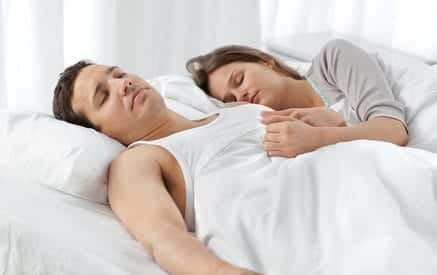Cute couple sleeping together on their bed