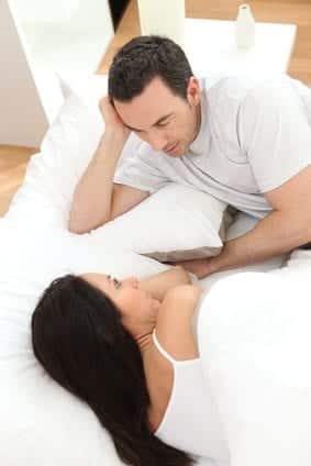 couple in bed talking